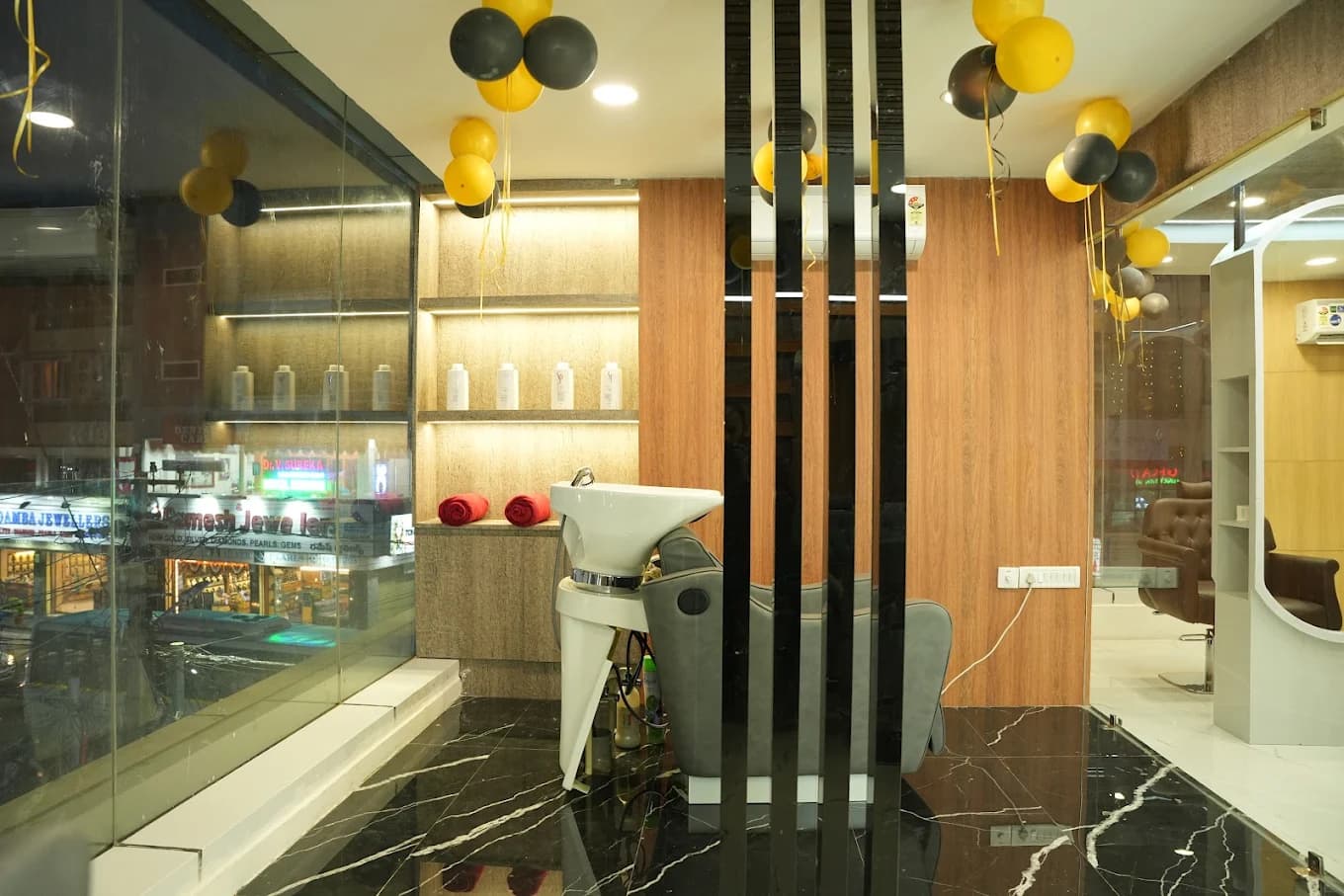 Malkajgiri salon: hairwash station with leather chair and product displays