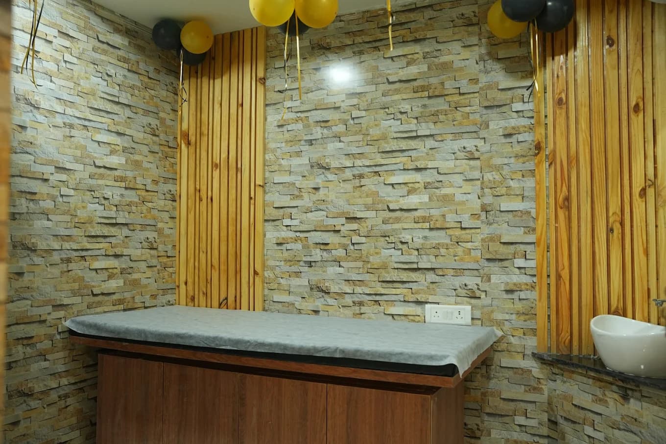Malkajgiri salon: facial / massage room with stone-clad walls