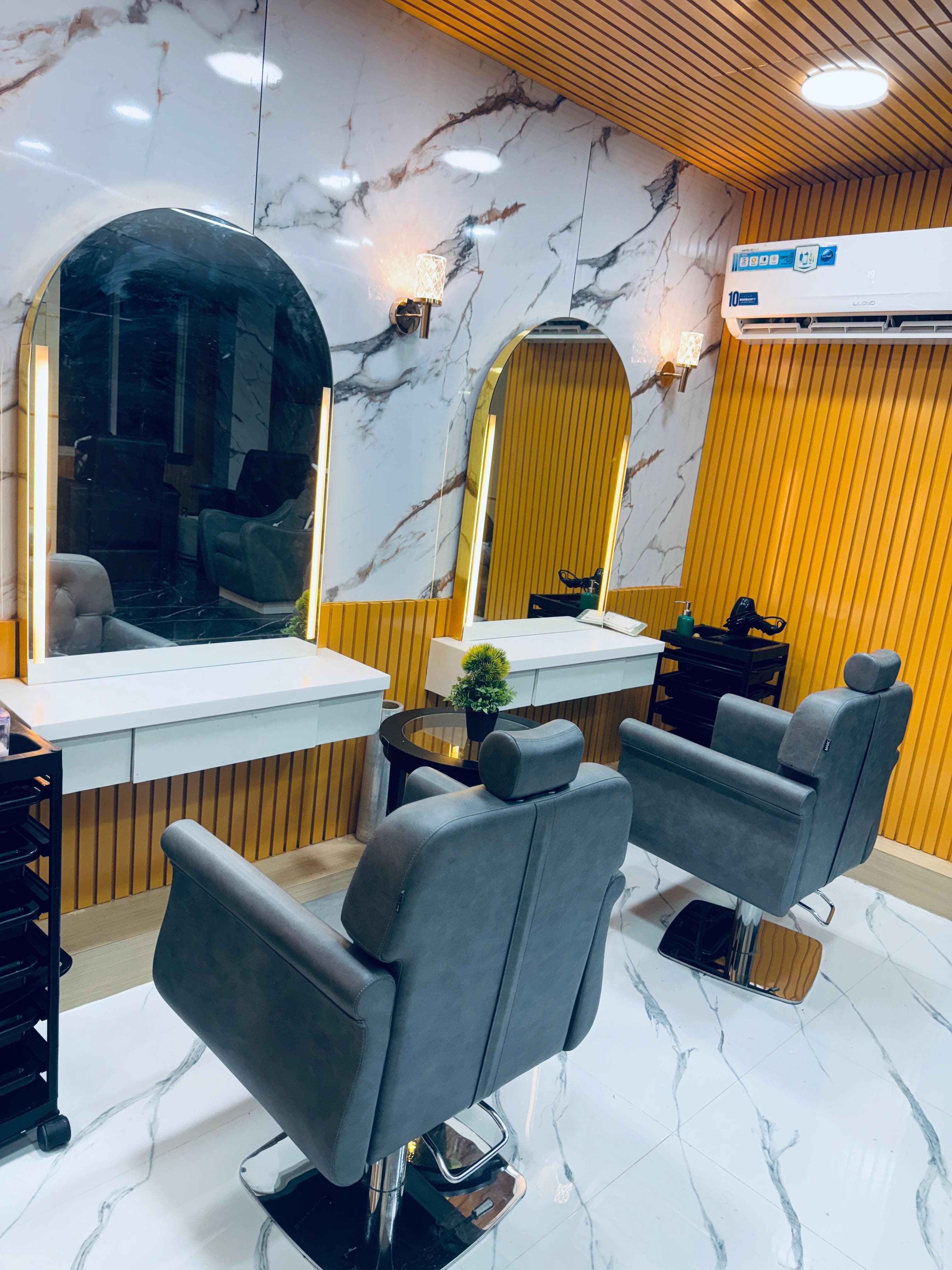 Sainikpuri salon: illuminated arched mirrors against marble and gold accents