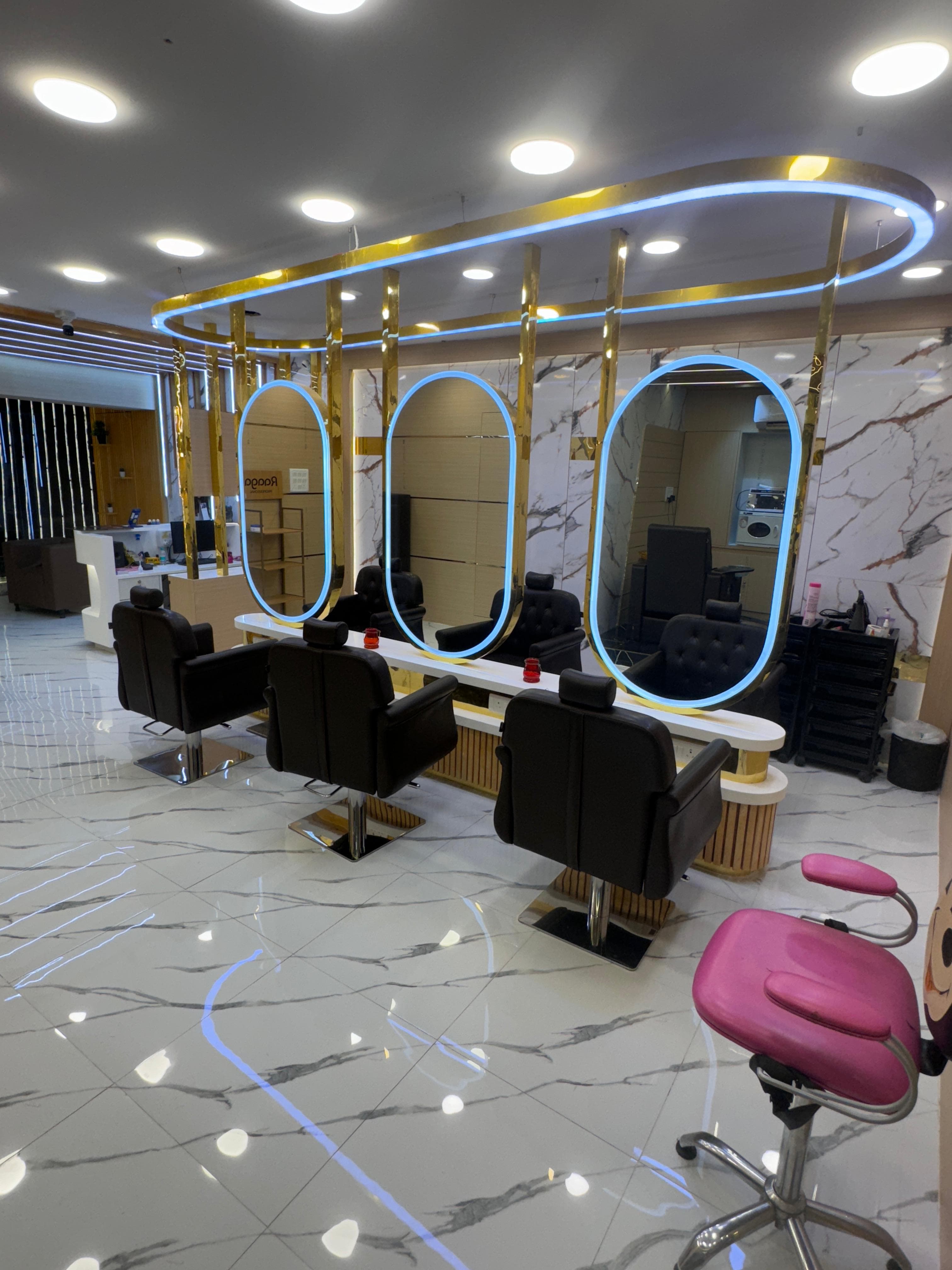 Sainikpuri salon: haircut stations with marble floors and gold fixtures